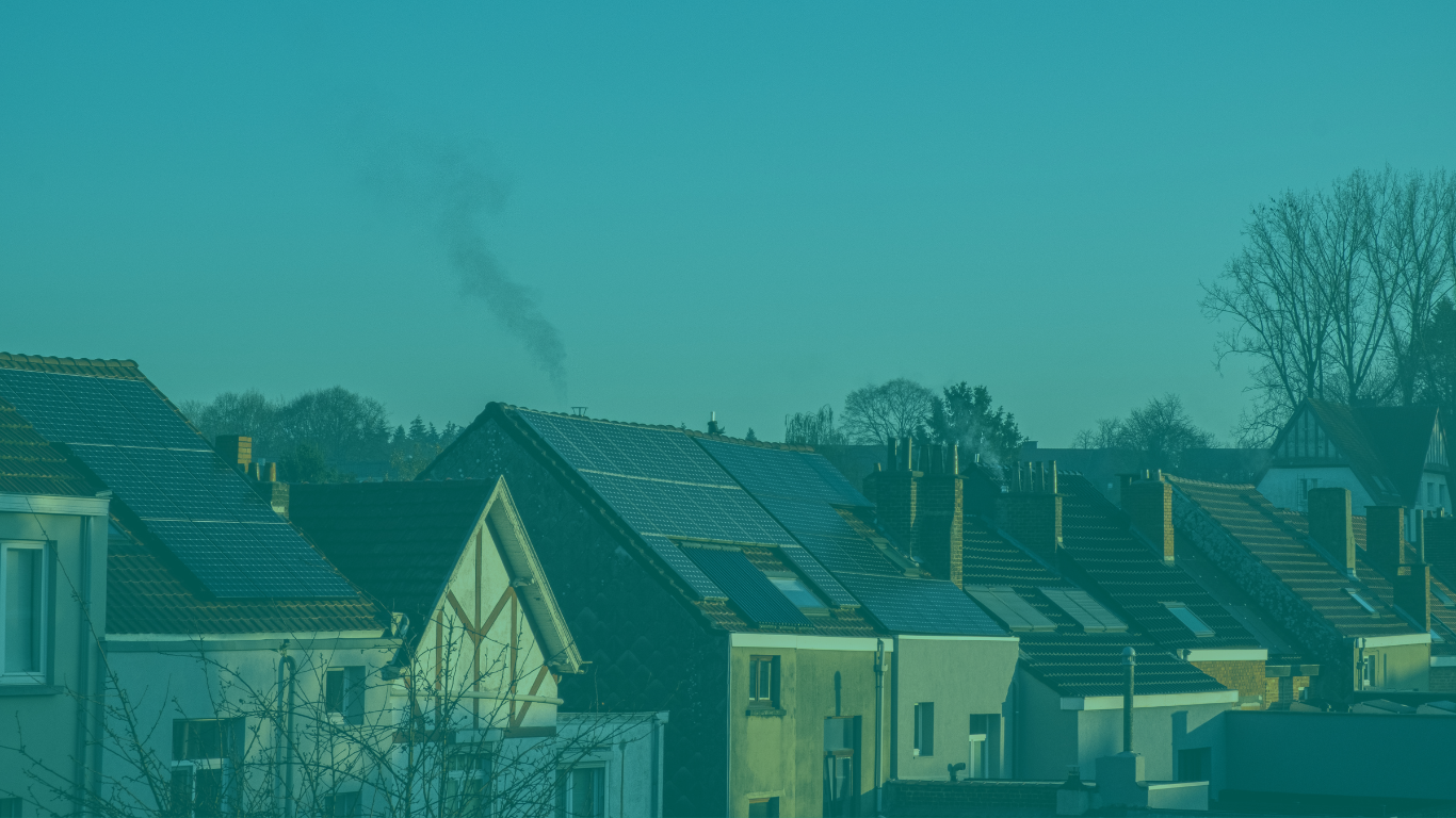 A row of houses with solar panels on the roofs with a blue filter