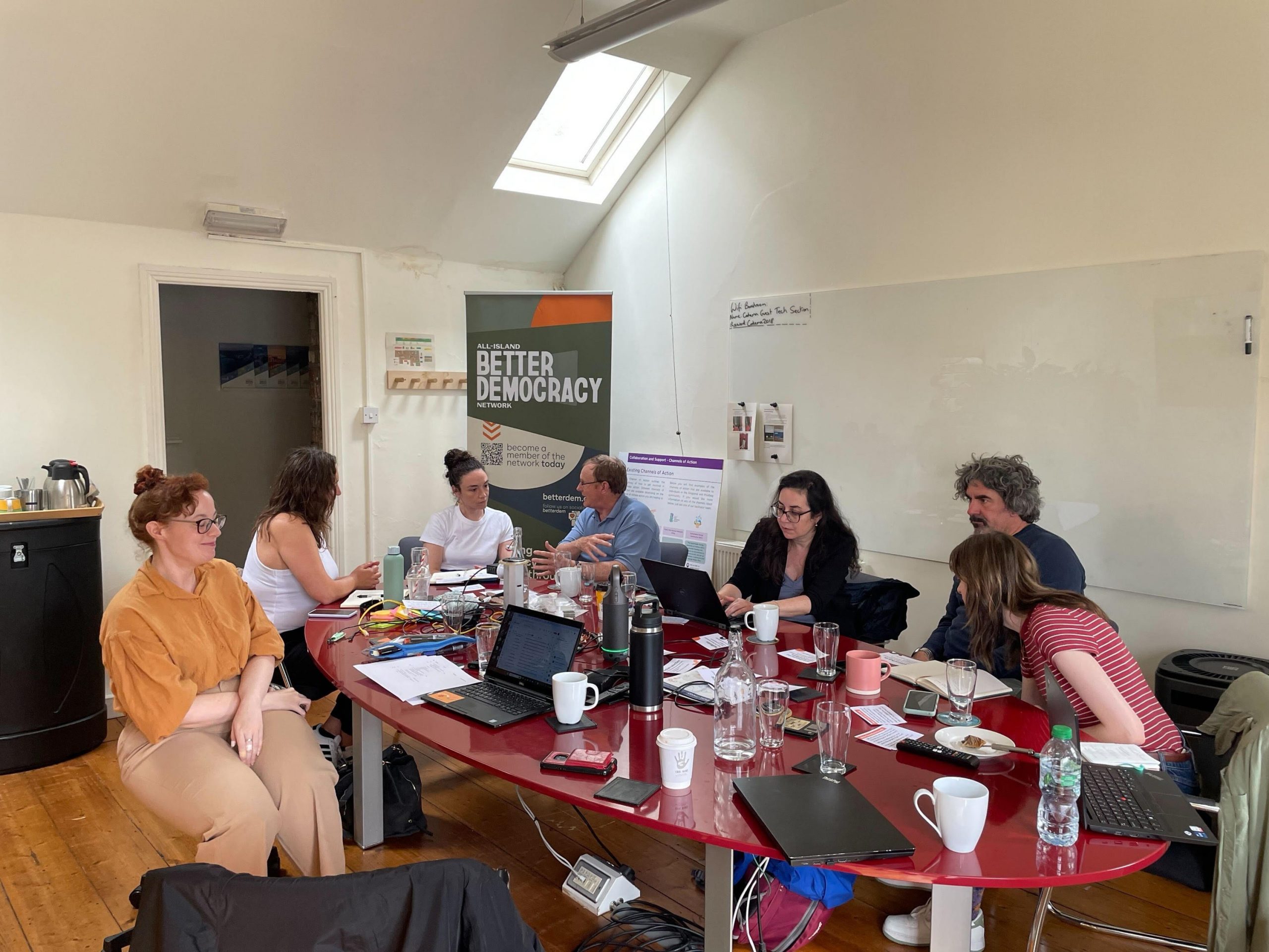 Members of the All-Island Better Democracy Network sititng around a large table having a discussion